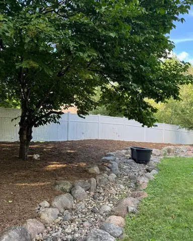 Landscaped area with rocks and tree in Lakeville, MN