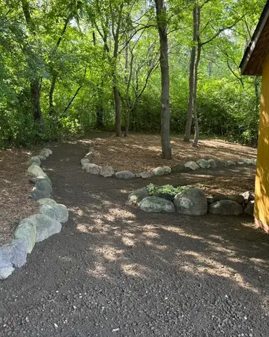 Pathway through wooded area with stone edging in Lakeville, MN
