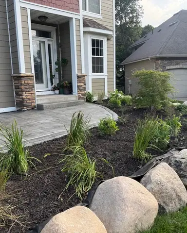 Landscaped area with rocks and trees in Lakeville, MN