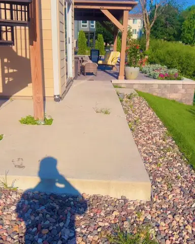 Paver patio with spiral staircase and landscaping in Lakeville, MN