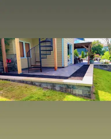 Paver patio with spiral staircase and landscaping in Lakeville, MN