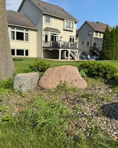Landscaped area with boulders and grass in Lakeville, MN