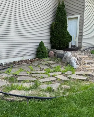 Landscaped area with boulders and grass in Lakeville, MN