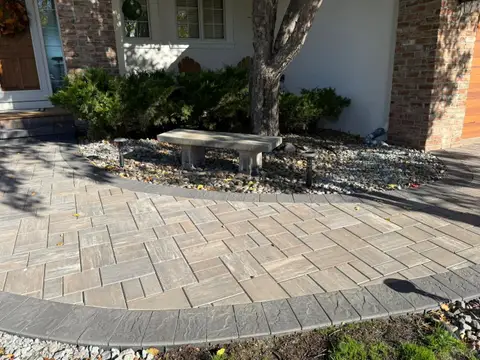 Curved paver walkway with bench and landscaping in Lakeville, MN