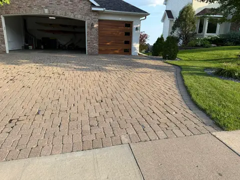 Paver driveway with gentle curve and landscaping in Lakeville, MN
