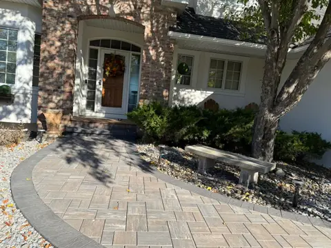 Front entrance with paver walkway and decorative plants in Lakeville, MN